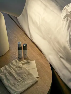 a bed with two bottles of medicine on a table at Seissta Medellín in Medellín