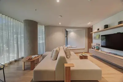 a living room with a couch and a flat screen tv at Seissta Medellín in Medellín