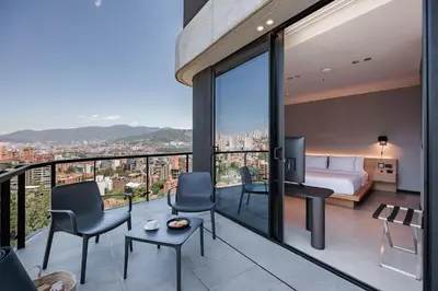 a bedroom with a view of a city at Seissta Medellín in Medellín