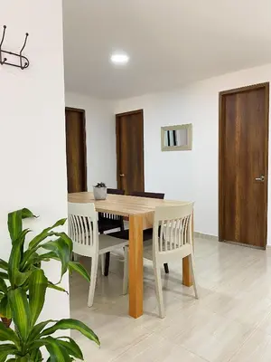 a dining room with a wooden table and chairs at Jardín de Primavera Apartamentos in Jardin