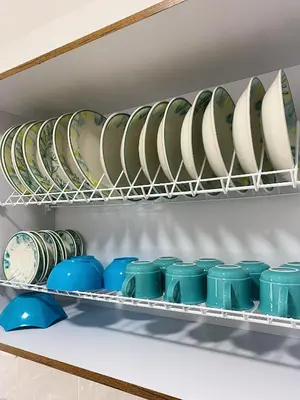 a bunch of plates and bowls on a shelf at Jardín de Primavera Apartamentos in Jardin