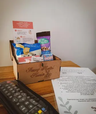 a box of junk food next to a computer keyboard at Famy Hostal Nardo's in Jardin
