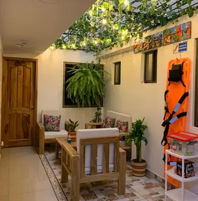 a living room with a ceiling with lights and plants at Famy Hostal Nardo's in Jardin