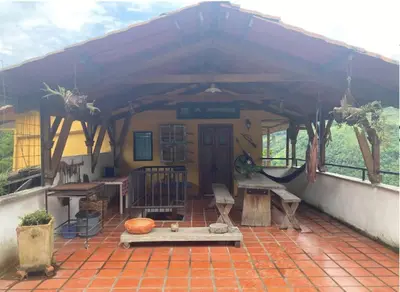 a house with a roof with a patio at Mirador de los Vientos in Manizales