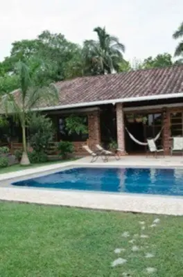 a house with a swimming pool in front of a house at Finca La Estación en Santa Fe de Antioquia in Santa Fe de Antioquia