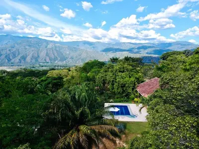 an aerial view of a house with a swimming pool and mountains at Finca La Estación en Santa Fe de Antioquia in Santa Fe de Antioquia