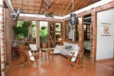 a living room with a table and chairs at Finca La Estación en Santa Fe de Antioquia in Santa Fe de Antioquia