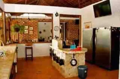 a kitchen with a stainless steel refrigerator and a counter at Finca La Estación en Santa Fe de Antioquia in Santa Fe de Antioquia