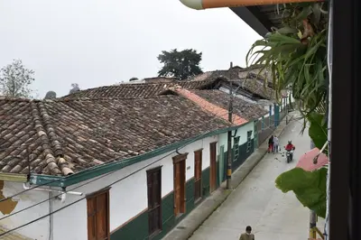 a group of people walking down a street with buildings at Acogedor apto en Sonsón in Sonsón