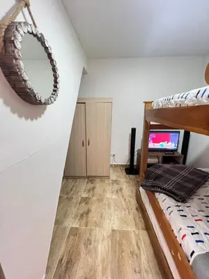 a bedroom with a bunk bed and a television at Acogedor apto en Sonsón in Sonsón