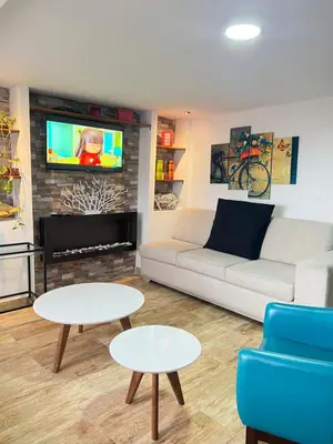 a living room with a couch and tables and a tv at Acogedor apto en Sonsón in Sonsón
