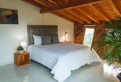 a bedroom with a large bed in a room at Hotel PIA Colombia in Marinilla