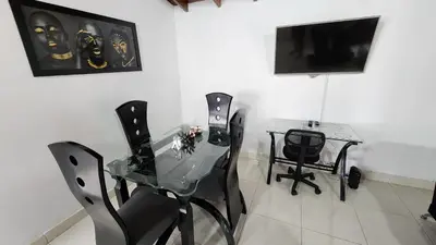a dining room with a glass table and chairs at amplio apartamento en envigado in Envigado