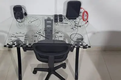 a glass table with a desk with a chair and clocks at amplio apartamento en envigado in Envigado