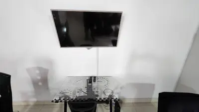 a white room with a table with a television on it at amplio apartamento en envigado in Envigado