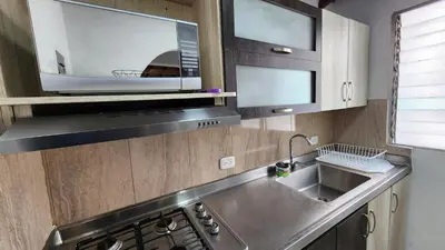 a kitchen with a sink and a microwave at amplio apartamento en envigado in Envigado