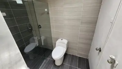 a bathroom with a toilet and a glass shower at amplio apartamento en envigado in Envigado