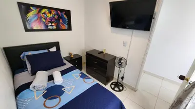 a bedroom with a bed with a painting of a lion at amplio apartamento en envigado in Envigado