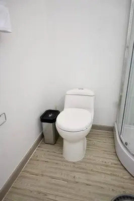 a bathroom with a toilet and a shower at Casa Flotante La Trinidad in Guatapé
