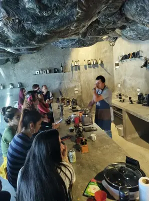 a group of people standing around a table in a kitchen at Cabaña Parque Arvi vista panorámica in Medellín