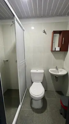 a bathroom with a toilet and a sink at MIRADORES DEL PARAISO in Doradal