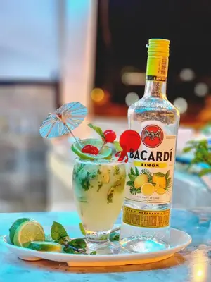 a bottle of alcohol next to a drink on a table at MIRADORES DEL PARAISO in Doradal
