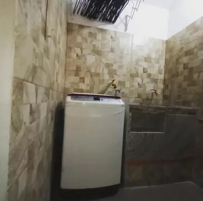 a bathroom with a sink and a small refrigerator at Casa Vacacional in Mariquita