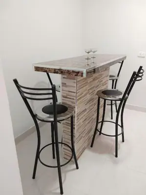 a bar with two chairs and a table with a counter at Casa Vacacional in Mariquita