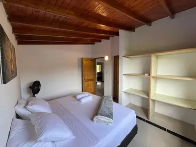 a bedroom with two beds and a wooden ceiling at Hotel Selva Cristal in San Carlos