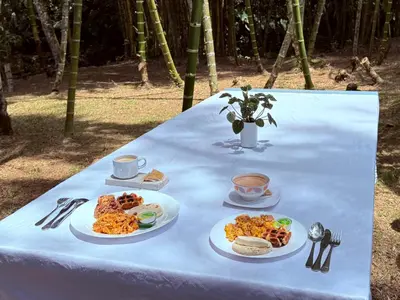 a table with plates of food on a blue table cloth at Hotel Selva Cristal in San Carlos