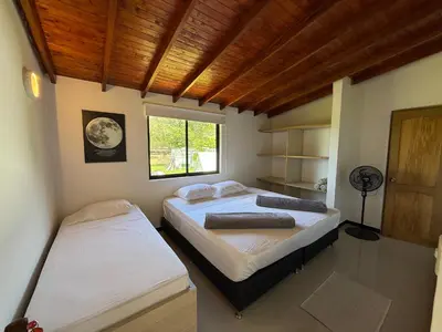a bedroom with two beds and a window at Hotel Selva Cristal in San Carlos