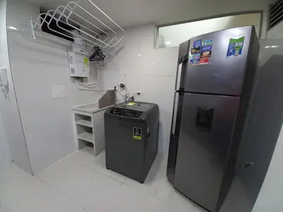 a kitchen with a stainless steel refrigerator and a sink at Apartamento amoblado en la Francia in Manizales