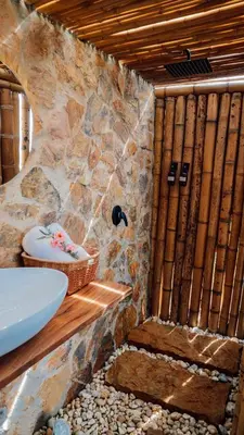 a bathroom with a stone shower with a sink at Cabañas con jacuzzi y chimenea - Casa Floral, Marinilla in Marinilla