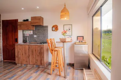 a kitchen with a counter and a sink and a refrigerator at Cabañas con jacuzzi y chimenea - Casa Floral, Marinilla in Marinilla