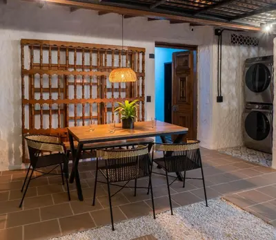 a dining room with a wooden table and chairs at Casa Medallo in Medellín