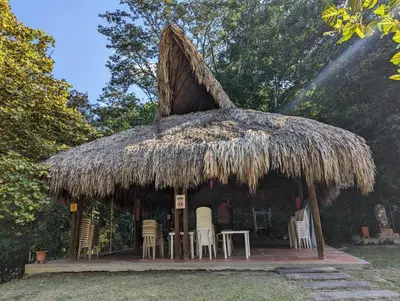 a small hut with chairs and a thatched roof at Apartasol en San Jerónimo, Ciudadela del Sol - Cammar in San Jerónimo