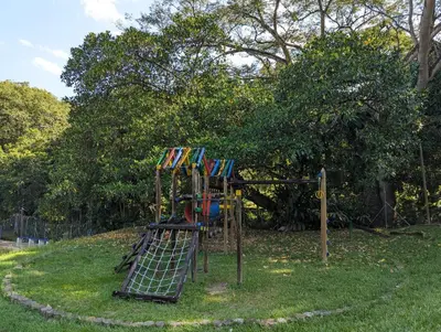 a playground with a slide in the grass at Apartasol en San Jerónimo, Ciudadela del Sol - Cammar in San Jerónimo