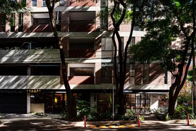 a tall building with a street in front of it at Súper apartamento en Laureles in Medellín