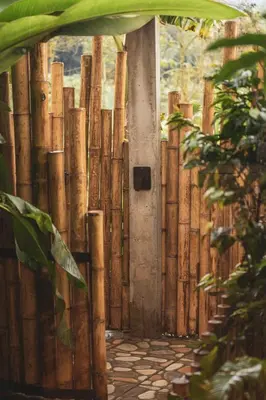 an entrance to a bamboo fence with a door at The Coffee Club Campestre in Chinchiná
