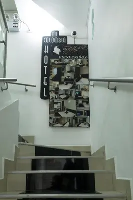 a staircase in a room with a poster on the wall at Ayenda 1254 Mi Colombia in Medellín