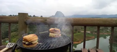 two sandwiches on a grill with a view of a mountain at Breeze Glamping -Guatape in El Peñol