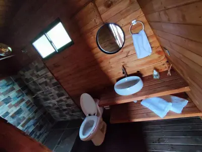 an overhead view of a bathroom with a toilet and a sink at Breeze Glamping -Guatape in El Peñol