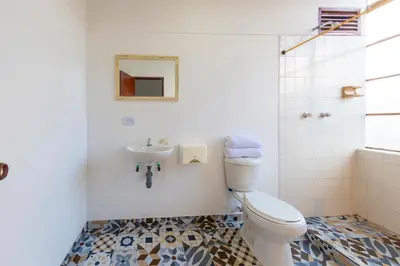 a bathroom with a toilet and a sink at Hotel Ayenda Macondo in Manizales