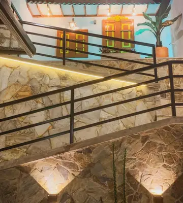 a set of stairs in a building with a stair railing at Apartahotel La Arboleda HC in Manizales