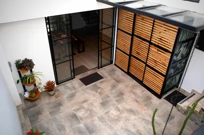 an overhead view of a patio with plants and windows at Apartahotel La Arboleda HC in Manizales