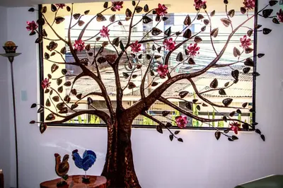 a painting of a tree with pink flowers on a wall at Apartahotel La Arboleda HC in Manizales