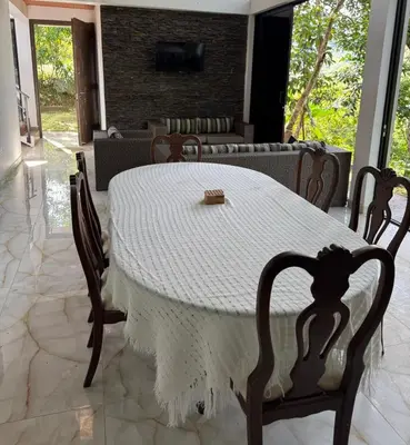 a table with a white table cloth on it in a room at EL MILAGRO FINCA VACACIONAL in San Rafael