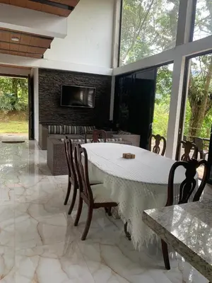 a dining room with a table and chairs and a fireplace at EL MILAGRO FINCA VACACIONAL in San Rafael