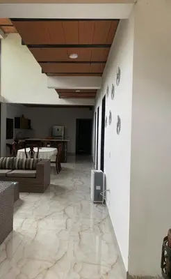 a living room with a couch and a tv on the wall at EL MILAGRO FINCA VACACIONAL in San Rafael