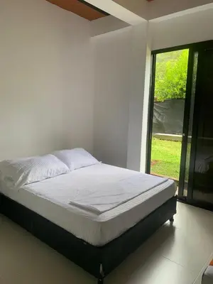 a bed in a white room with a window at EL MILAGRO FINCA VACACIONAL in San Rafael